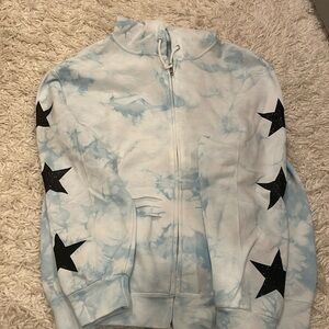Blue zip up with black stars 
Slightly worn
Good condition